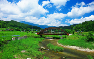 Мост через речку в зеленой долине.