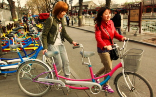 Девушки с двухместным велосипедом